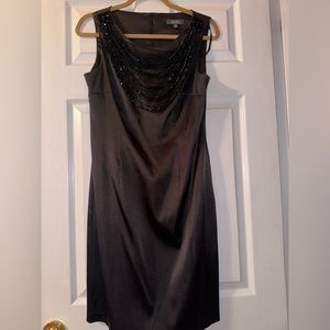 Black statin with attached beaded necklace